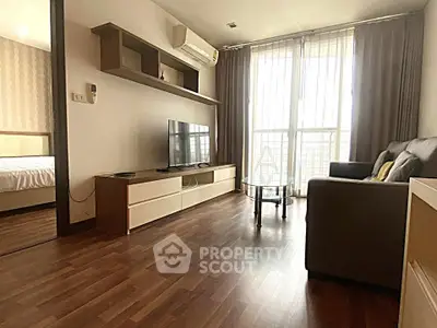 Modern living room with sleek furniture and natural light in a stylish apartment.