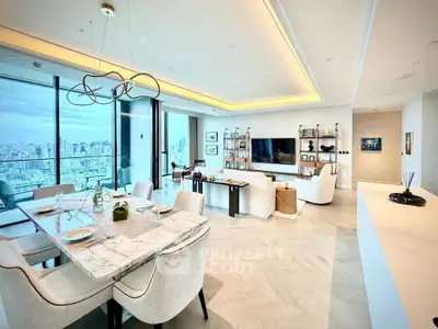 Luxurious open-plan living and dining area with stunning city views and modern decor.