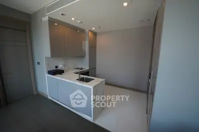 Modern kitchen with sleek cabinetry and marble countertops in a stylish apartment.