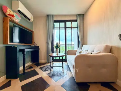 Charming living room with elegant decor and balcony view, perfect for relaxation and entertaining.