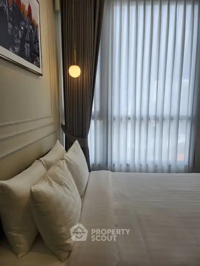 Elegant bedroom with modern decor and soft lighting, featuring a cozy bed and floor-to-ceiling windows.