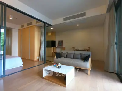 Modern open-plan living room with stylish decor and natural light