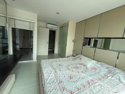 Spacious bedroom with modern decor and large bed in a stylish apartment.
