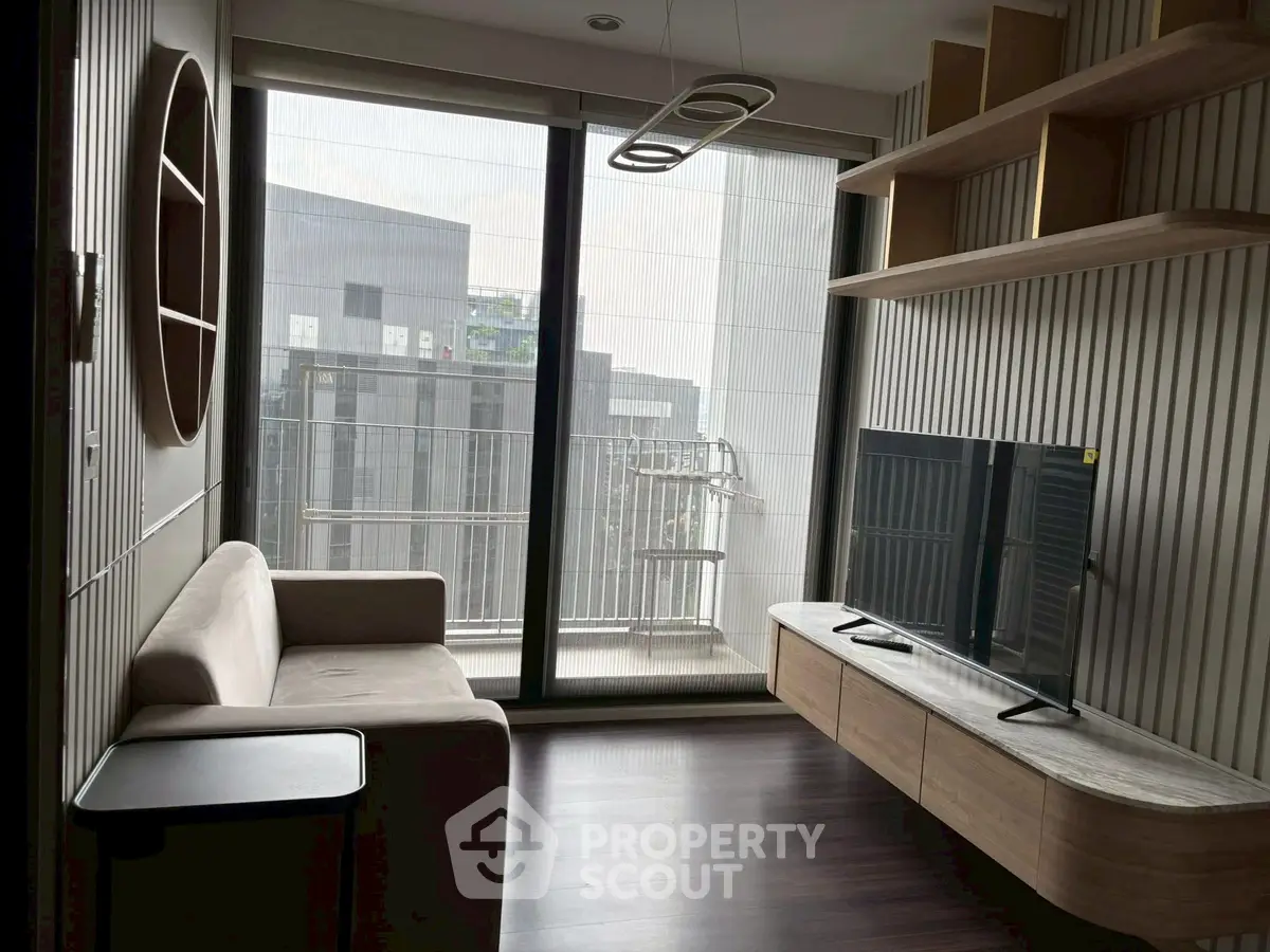 Modern living room with sleek furniture and balcony view in urban apartment