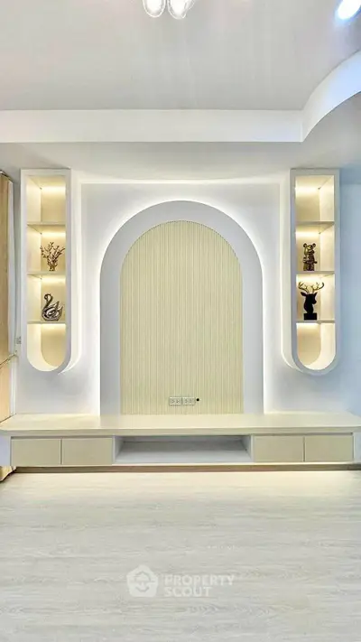 Modern living room with elegant built-in shelving and soft lighting