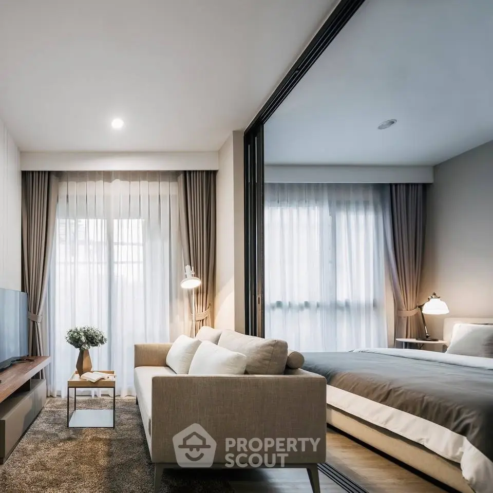 Modern studio apartment with stylish living area and cozy bedroom