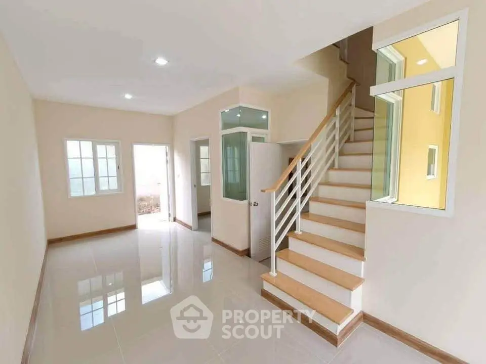 Spacious modern living room with staircase and natural light