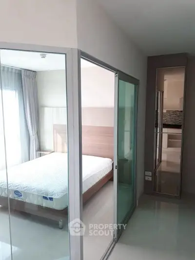 Modern bedroom with glass sliding doors and natural light