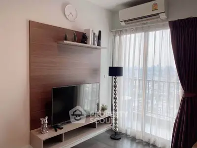 Modern living room with TV, stylish decor, and large window offering city view.