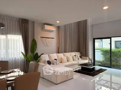 Spacious modern living room with elegant decor and large windows for natural light.