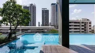 Luxurious rooftop pool with stunning city skyline views in modern urban setting.