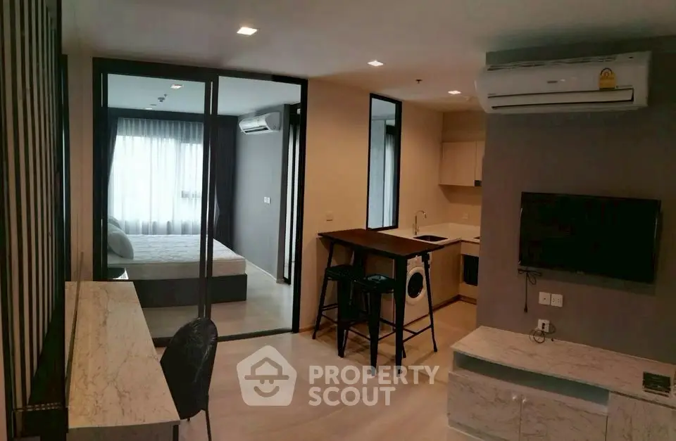 Modern open-plan living room with kitchen and bedroom in stylish apartment