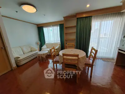 Spacious living room with natural light and cozy seating area