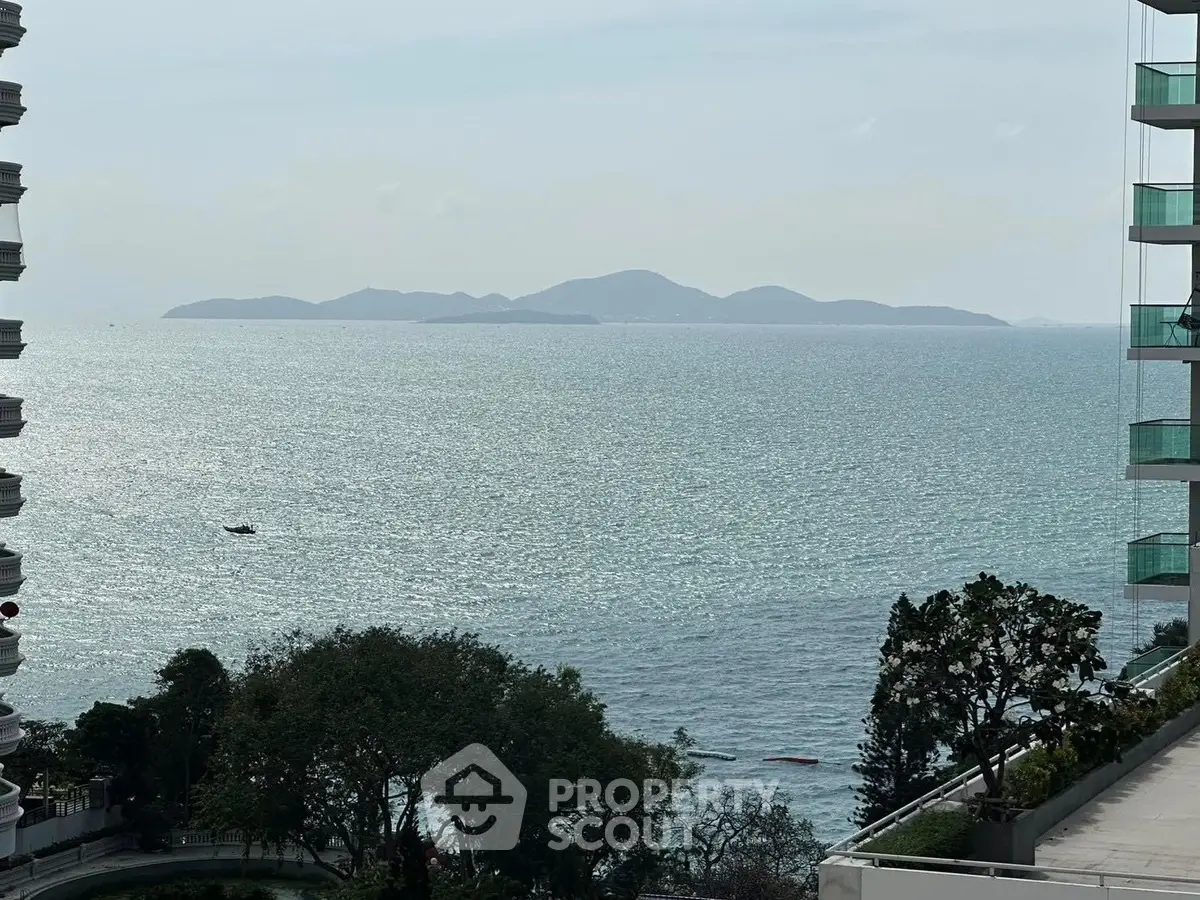 Stunning ocean view from high-rise balcony with distant islands and serene waters.