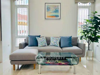 Stylish living room with modern sofa and glass coffee table, bright and inviting space.
