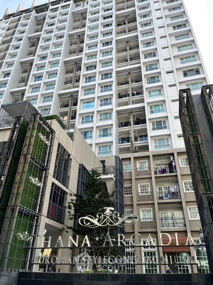 Modern high-rise condominium with European architectural style and lush greenery.