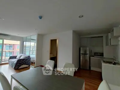 Modern apartment with open layout, featuring a cozy living area and sleek kitchen.