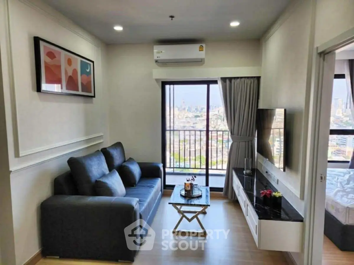 Modern living room with city view, stylish sofa, and wall-mounted TV in a high-rise apartment.