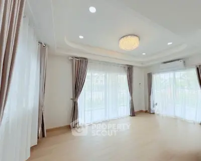 Spacious and bright living room with elegant curtains and modern lighting