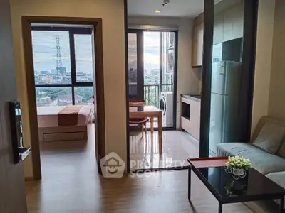 Modern apartment with open layout, featuring a cozy living area, sleek kitchen, and stunning city view from the balcony.