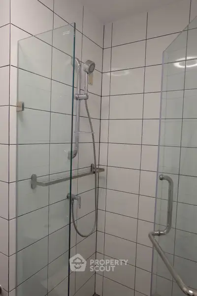 Modern bathroom shower with glass doors and tiled walls