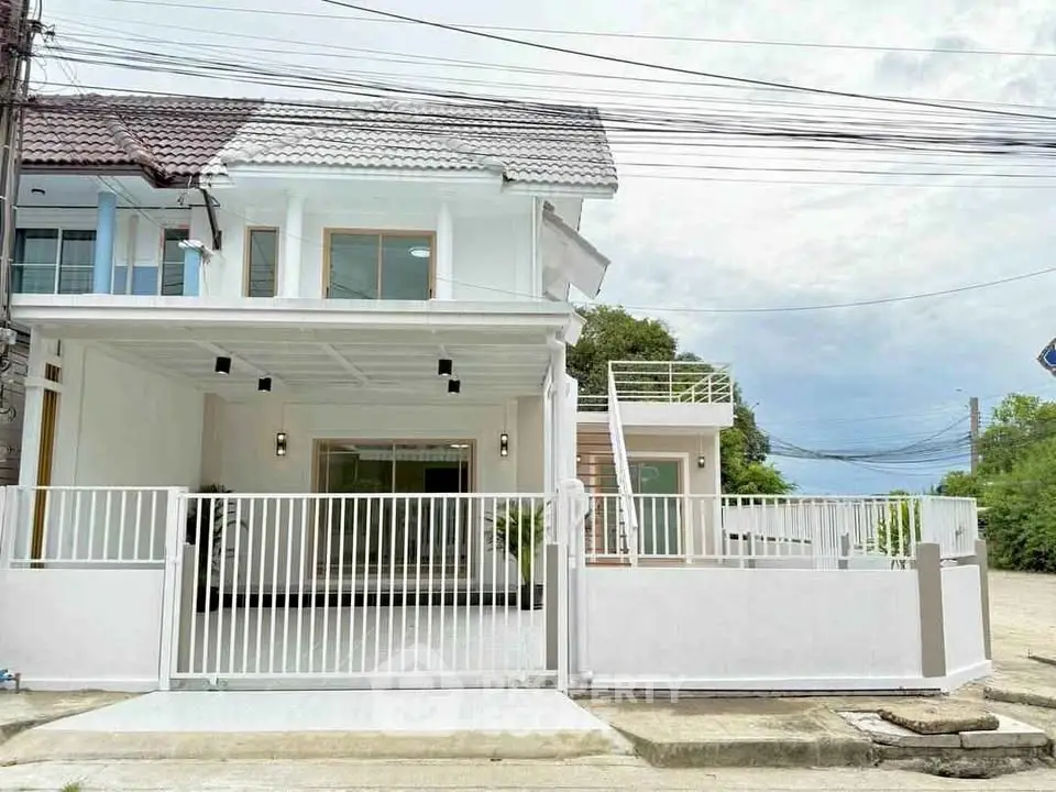 Charming two-story white house with modern design and spacious outdoor area.
