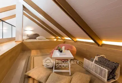 Charming attic living space with cozy seating and modern decor