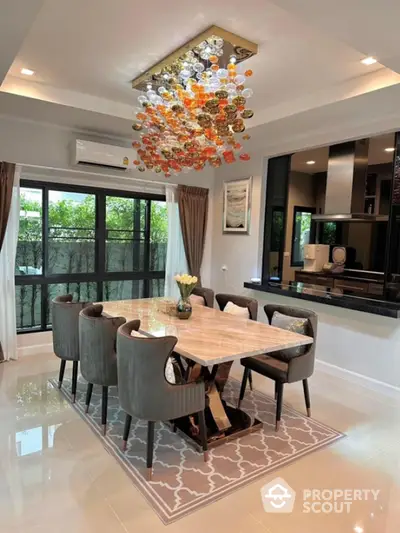 Elegant dining room with modern chandelier and large windows