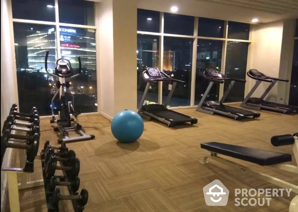 Modern gym with city view in luxury apartment building