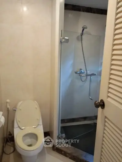 Modern bathroom with glass shower and toilet in a sleek design