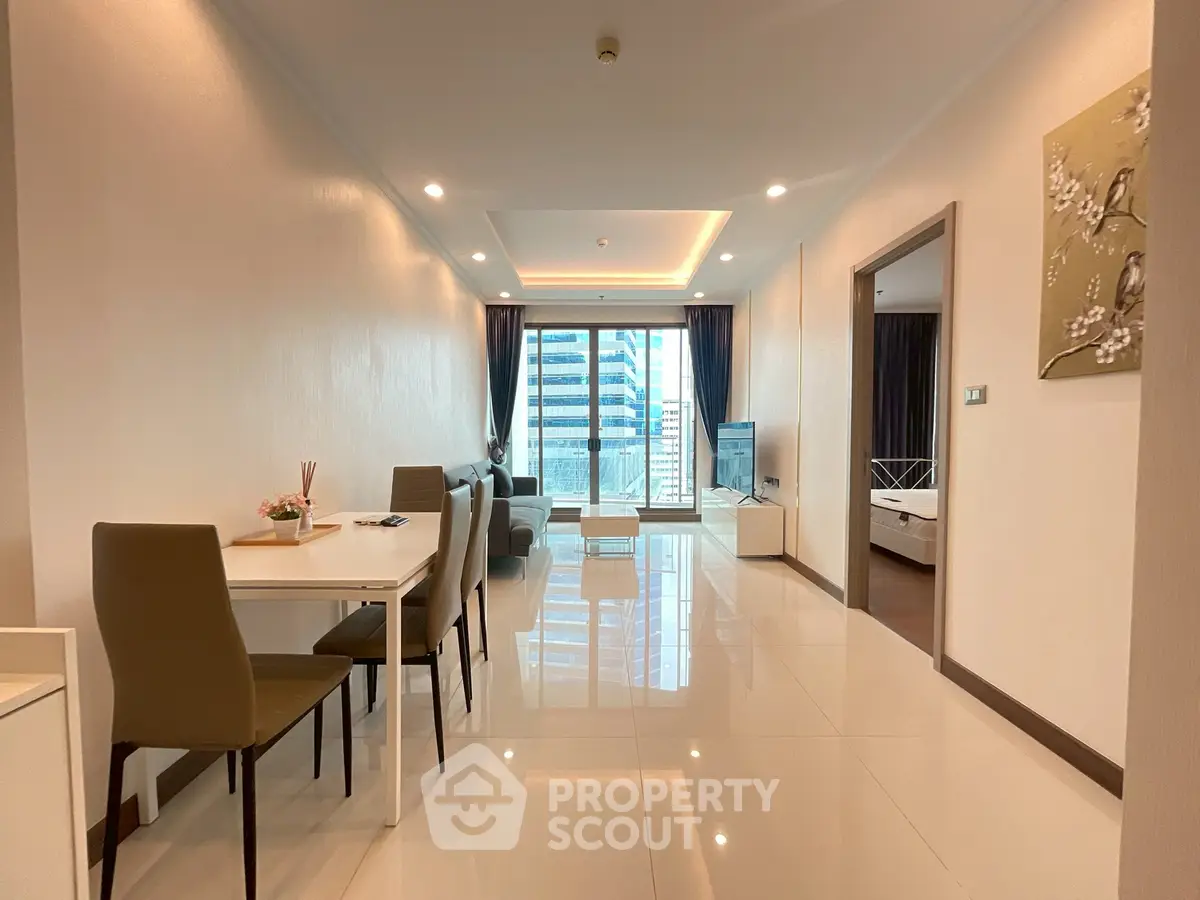 Modern living room with sleek dining area and city view, perfect for urban living.