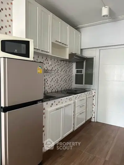 Modern kitchen with sleek appliances and stylish cabinetry in a contemporary home.