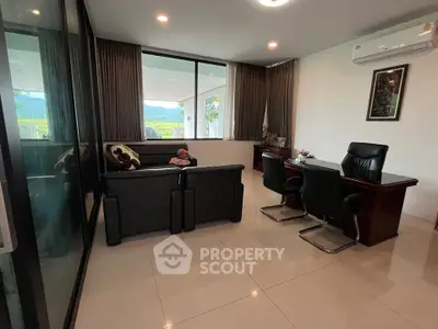 Modern living room with sleek furniture and large windows offering scenic views.