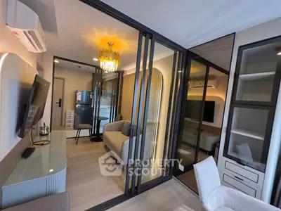 Modern living room with glass partitions and elegant lighting