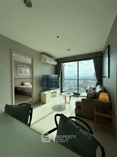 Modern living room with city view and cozy furnishings in high-rise apartment
