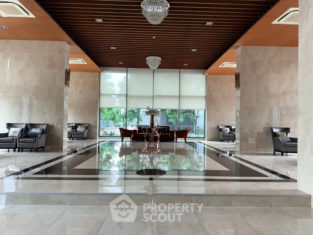 Luxurious building entrance with elegant seating and chandeliers