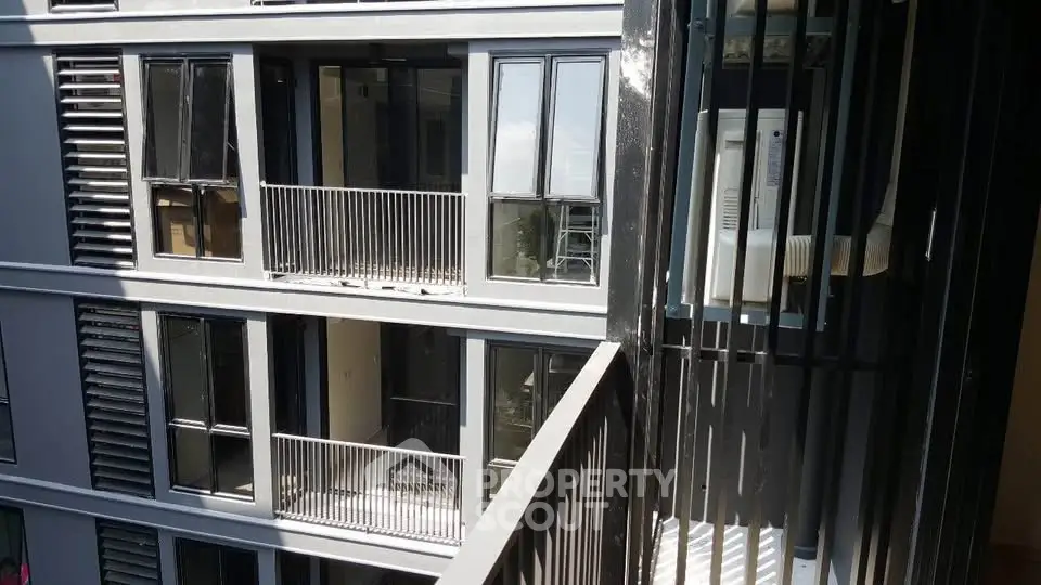 Modern apartment building exterior with balconies and sleek design