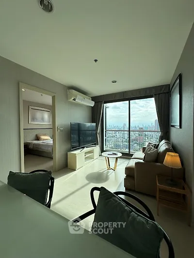 Modern living room with city view and cozy furnishings in high-rise apartment