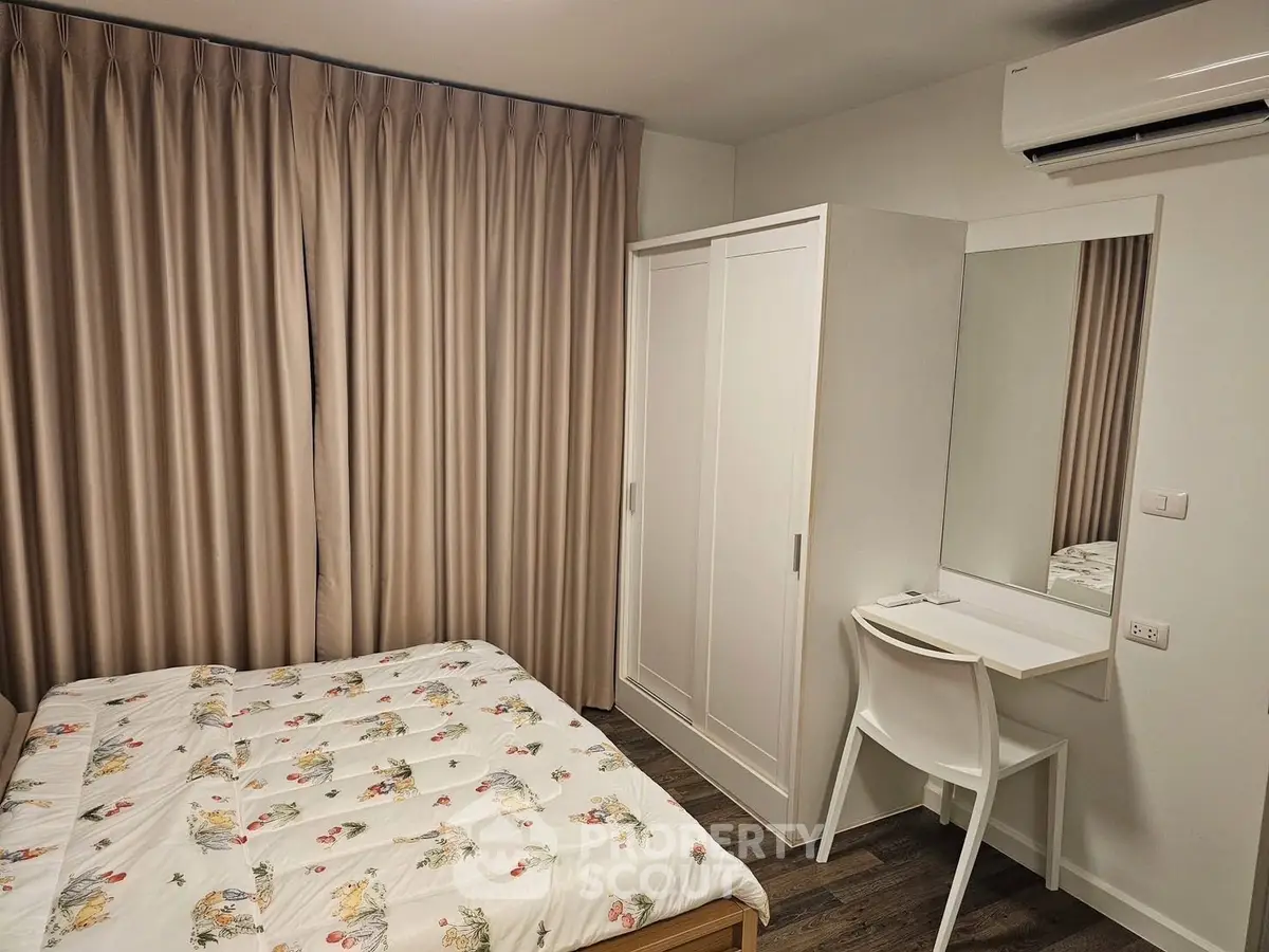 Cozy bedroom with modern furniture and air conditioning, perfect for comfort and relaxation.