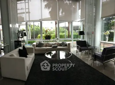 Luxurious modern living room with large windows and elegant furniture