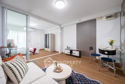 Modern living room with stylish decor and open layout, featuring a cozy seating area and dining space.