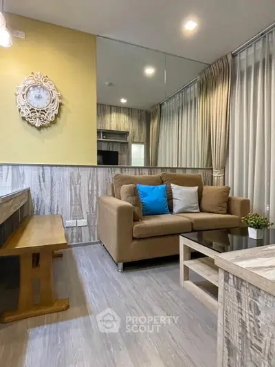 Charming living room with cozy sofa, stylish decor, and natural light, perfect for relaxation and entertaining.