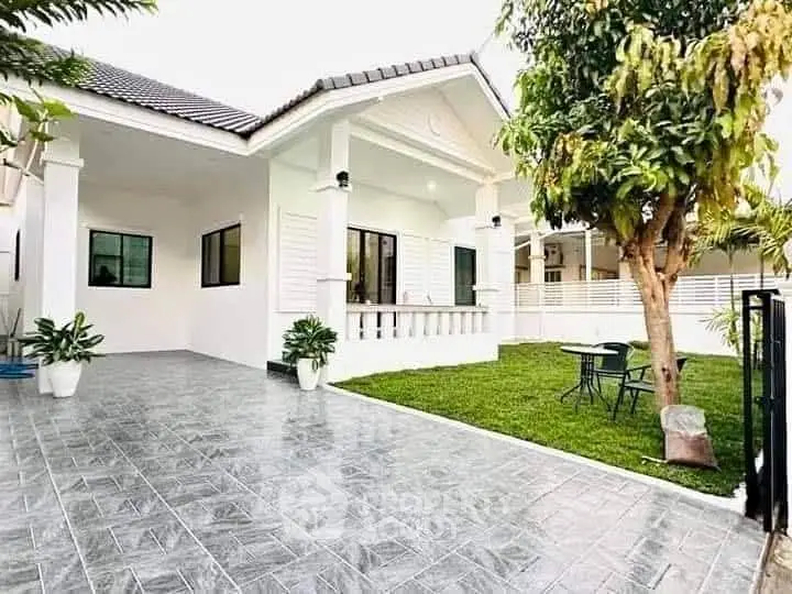 Charming single-story home with spacious garden and tiled driveway
