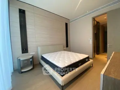 Modern bedroom with sleek design and comfortable mattress in luxury apartment.