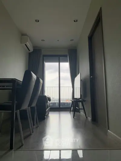 Modern apartment living room with sleek furniture and balcony view