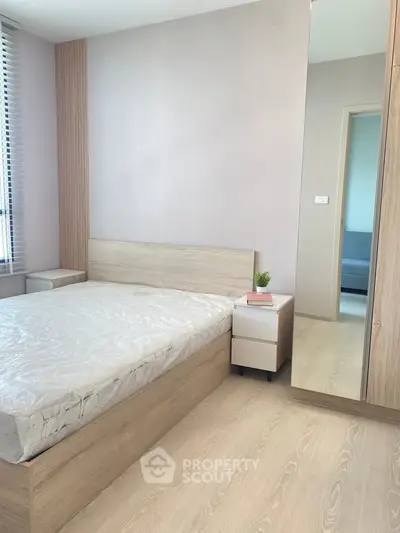 Modern bedroom with minimalist design and large mirror wardrobe