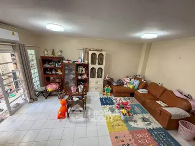 Spacious living room with cozy seating and playful decor, perfect for family gatherings.