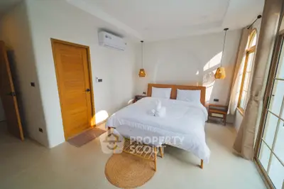 Spacious bedroom with modern decor and natural light, featuring a cozy bed and stylish lighting.