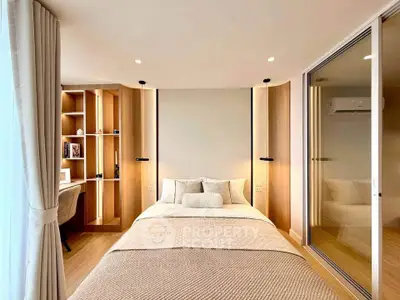 Modern bedroom with cozy decor and built-in study area, featuring elegant lighting and wooden accents.