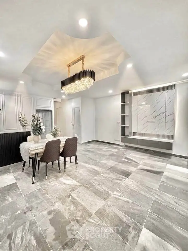 Luxurious modern dining area with elegant chandelier and marble flooring